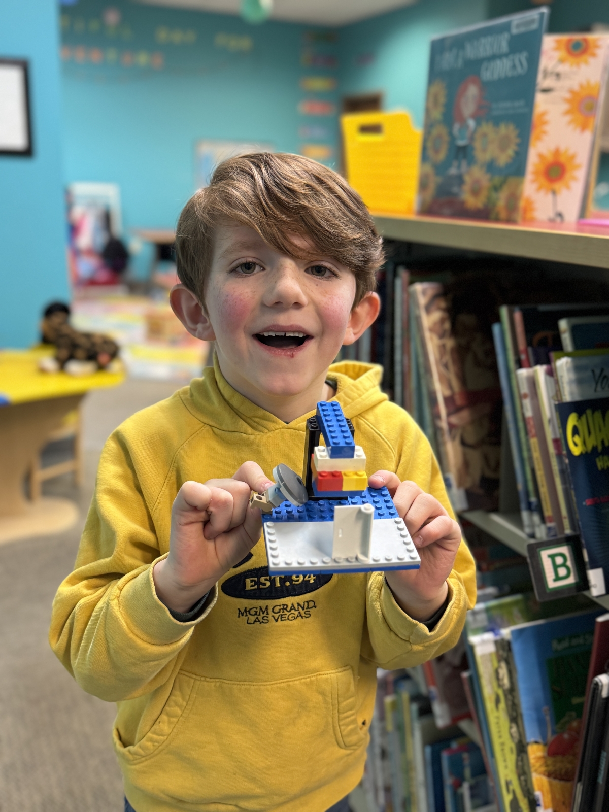 boy holding a small lego 