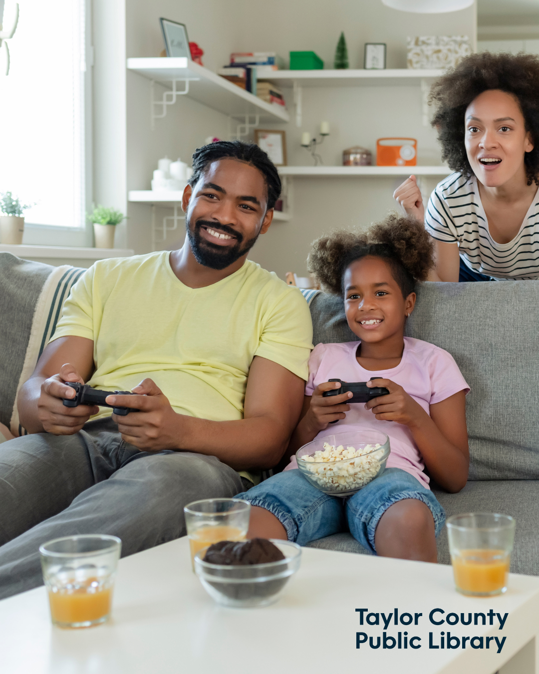 parents and a child playing video games together