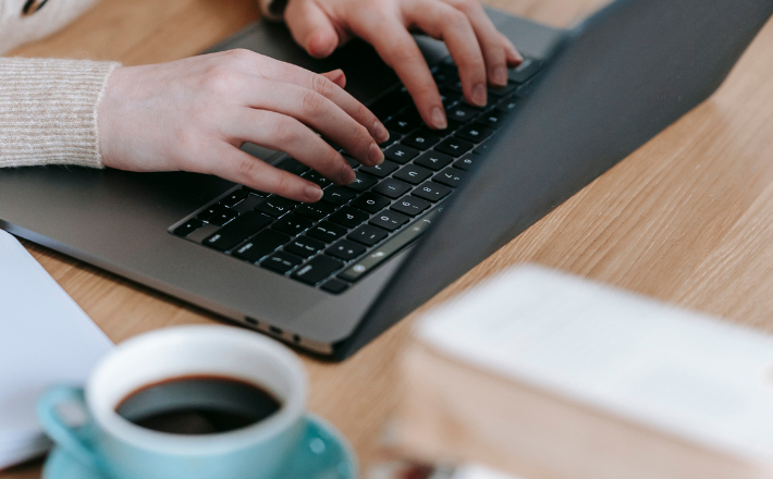 Woman on her laptop with a cup of coffee