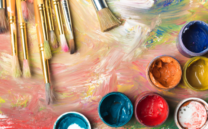 Paints and paint brushes on a canvas